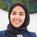 happy successful muslim businesswoman posing outside